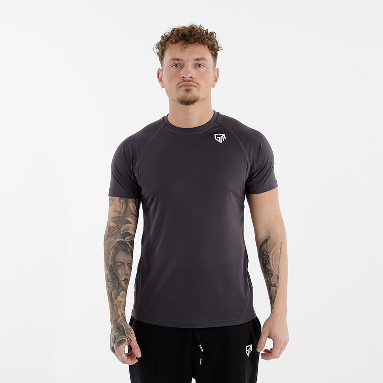 Front view of a man wearing an active panel t-shirt in charcoal