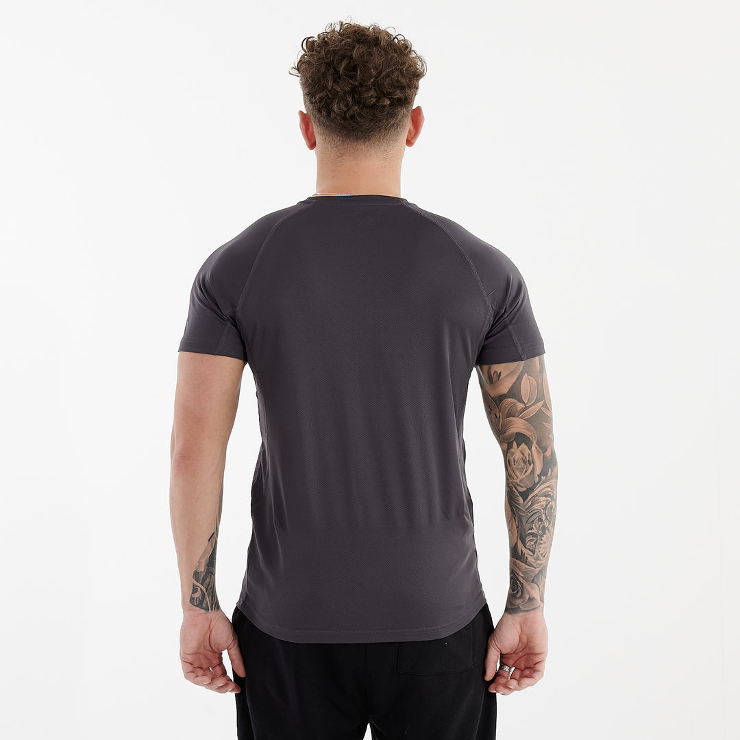 Back view of a man wearing an active panel t-shirt in charcoal