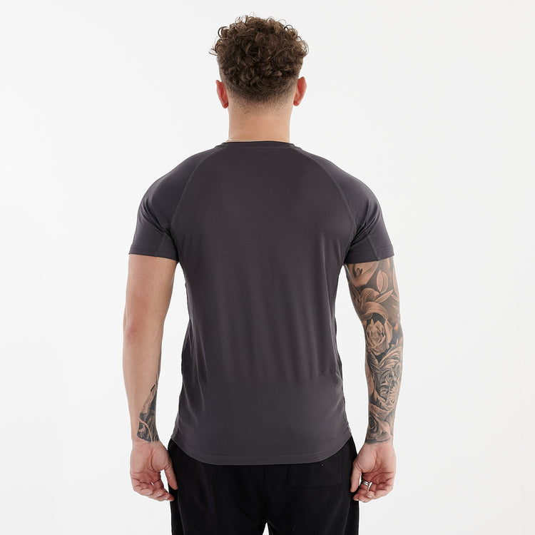 Back view of a man wearing an active panel t-shirt in charcoal