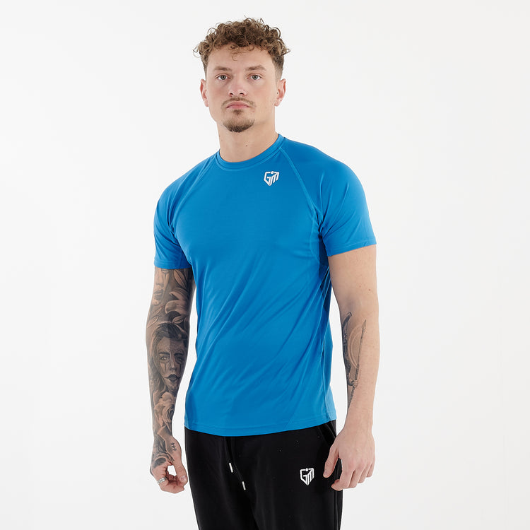 Side view of a man wearing an active panel t-shirt in sapphire