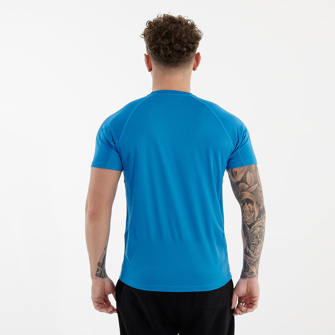 Back view of a man wearing an active panel t-shirt in sapphire