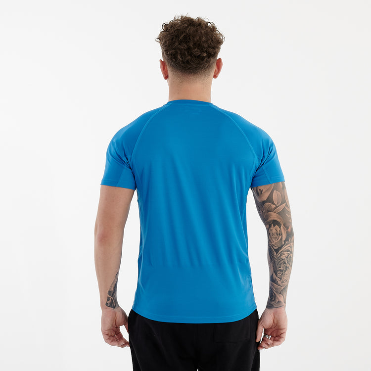 Back view of a man wearing an active panel t-shirt in sapphire
