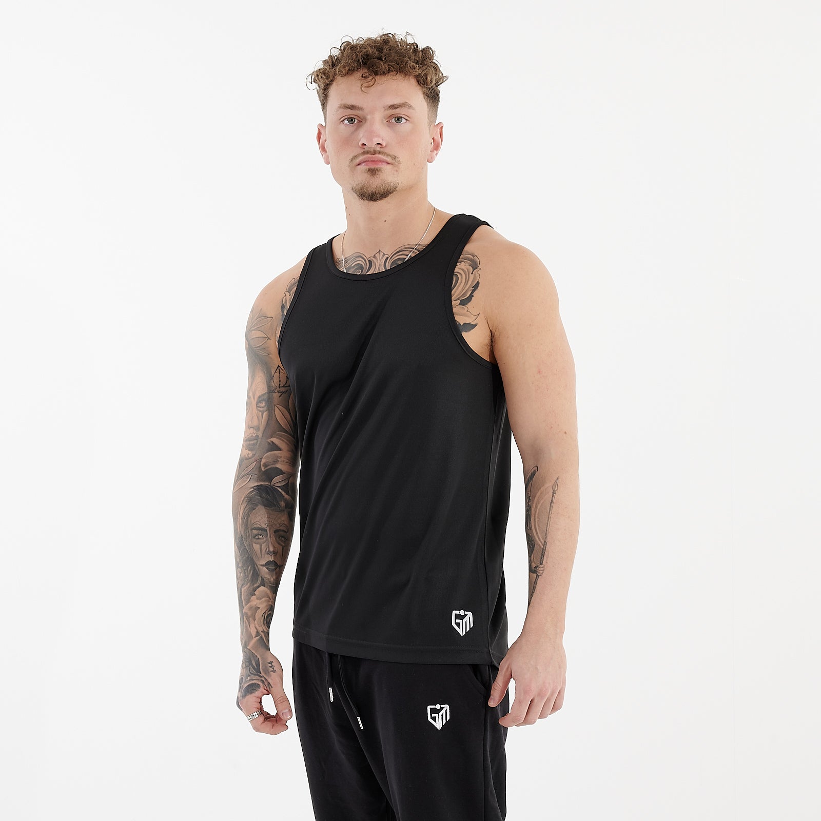 Side view of a man wearing a jet black cool performance vest