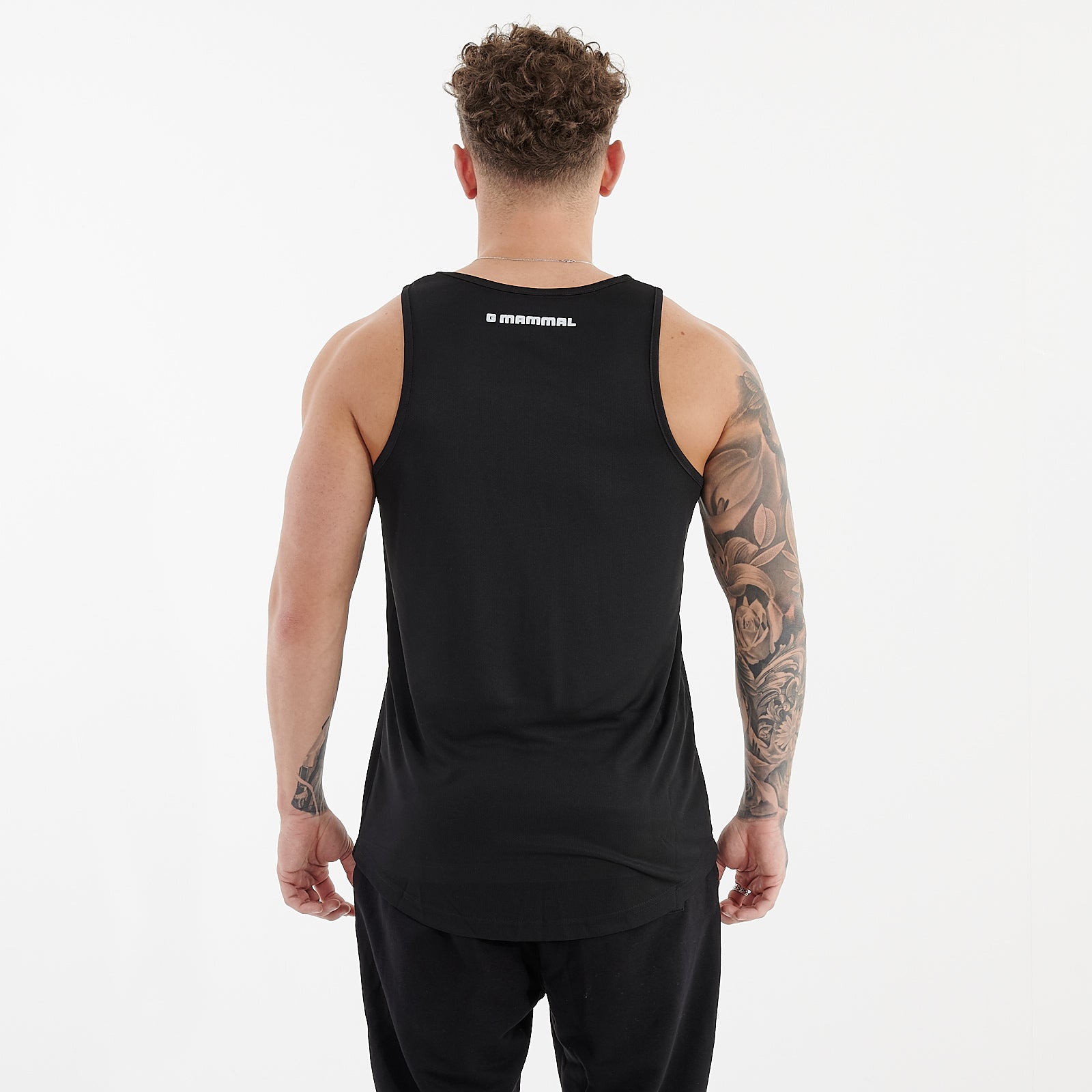 Back view of a man wearing a jet black cool performance vest