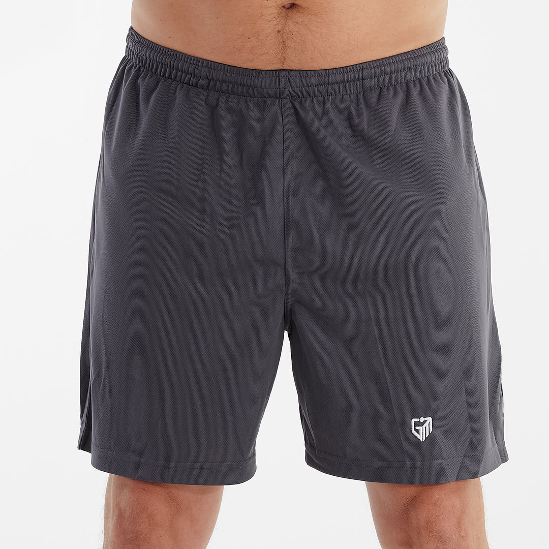 Front view of a man wearing charcoal cool workout shorts