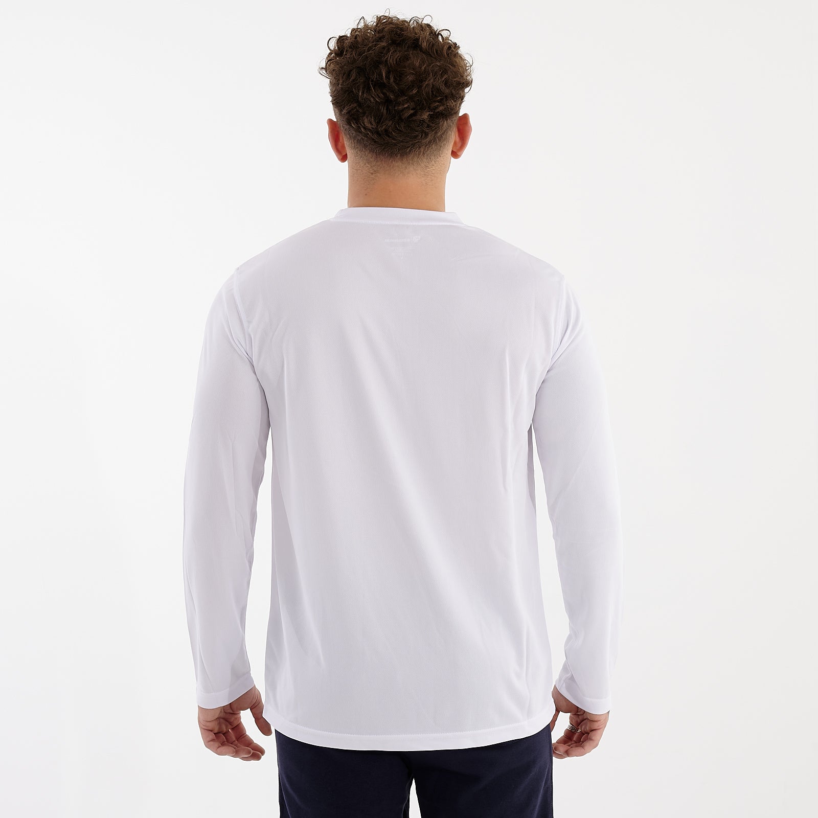 Back view of a man wearing a long sleeve white cool t-shirt