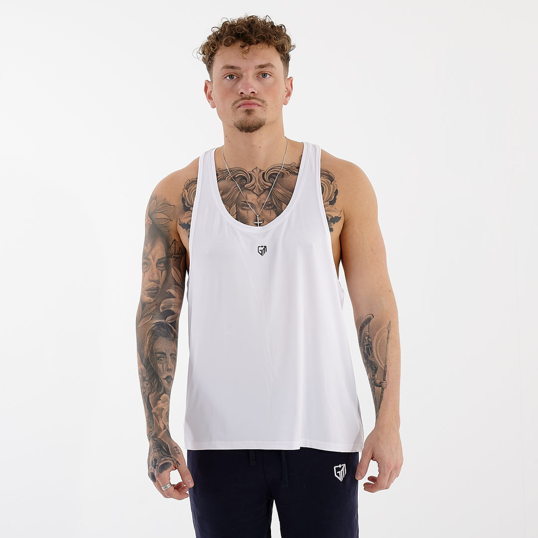 Front view of a man wearing a white essential muscle tank top