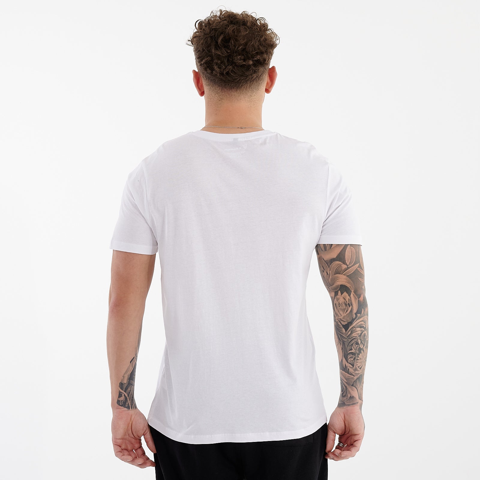 Back view of a man wearing a white organic everyday t-shirt