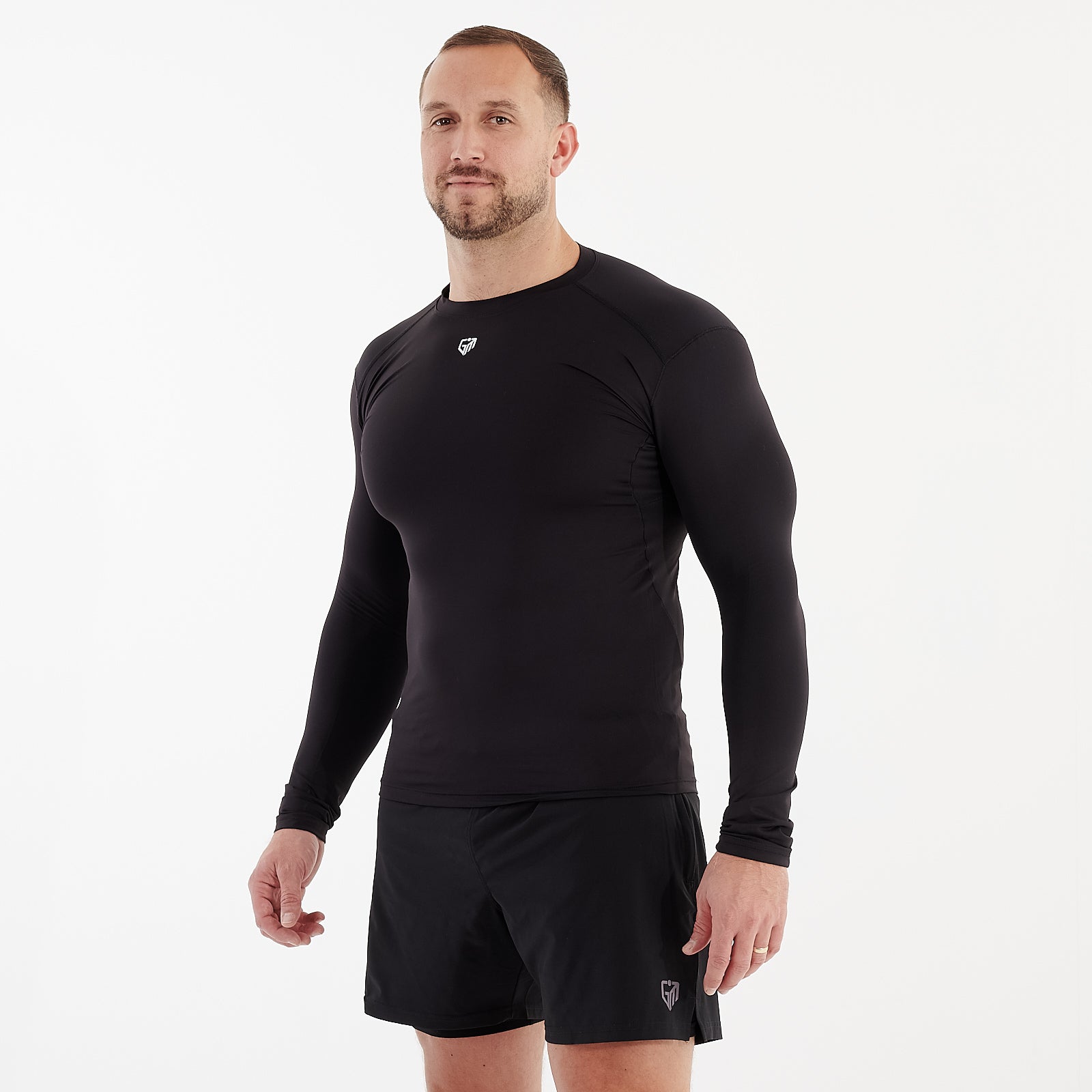 Side view of a man wearing a black performance baselayer 