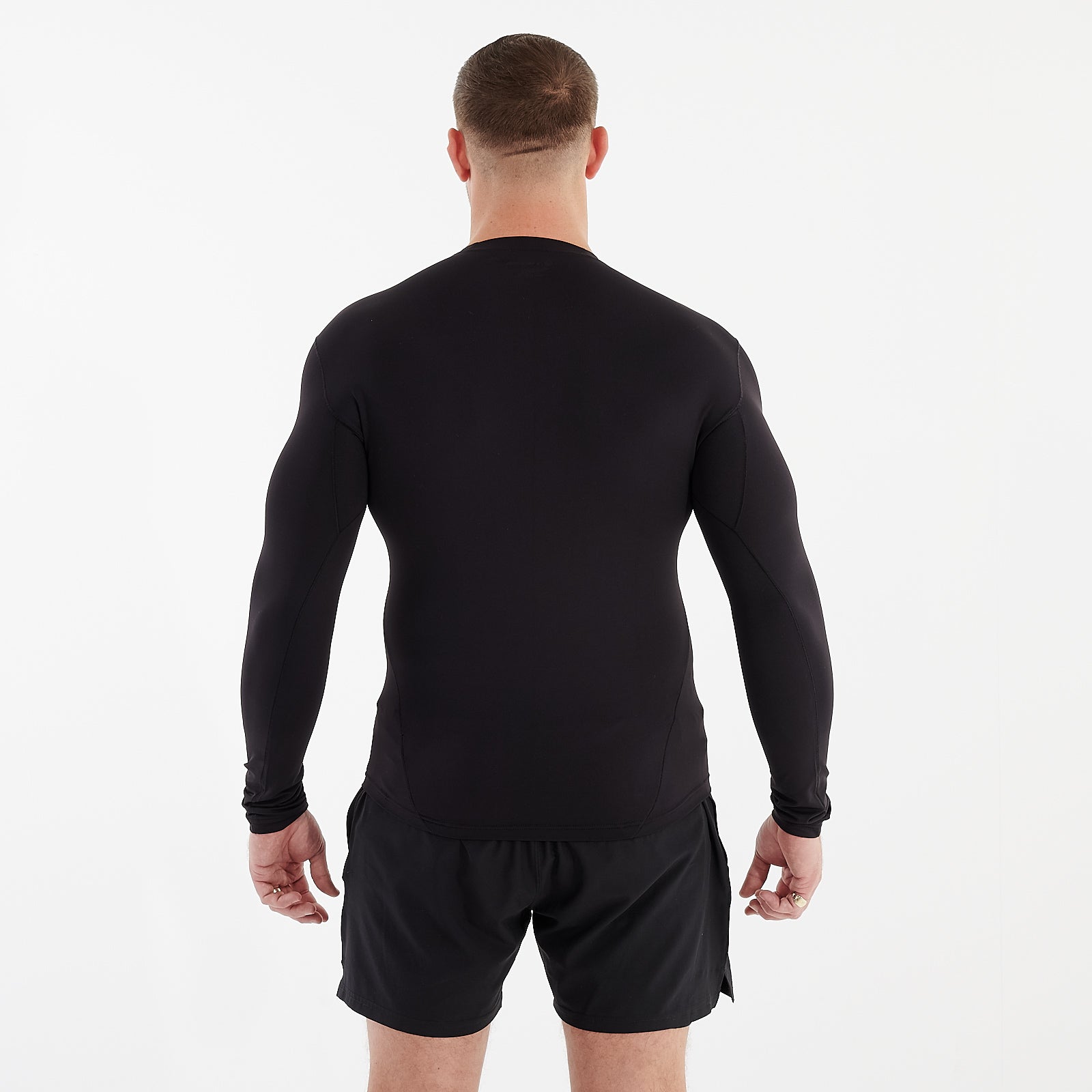 Back view of a man wearing a black performance baselayer 