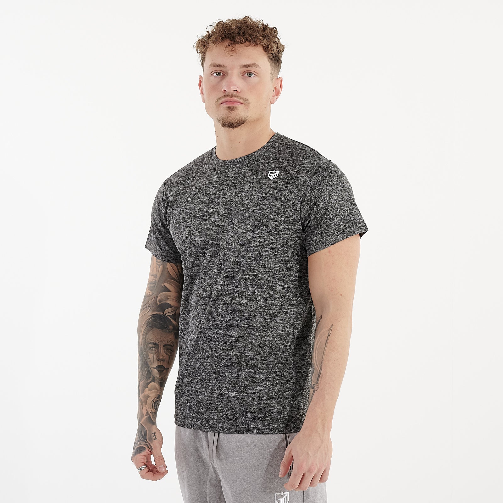 Side view of a man wearing a asphalt performance recycled tee
