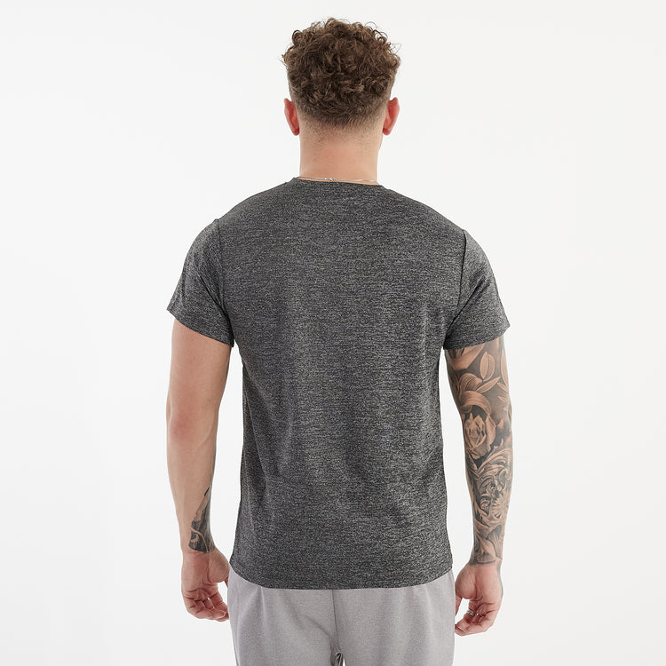 Back view of a man wearing a asphalt performance recycled tee