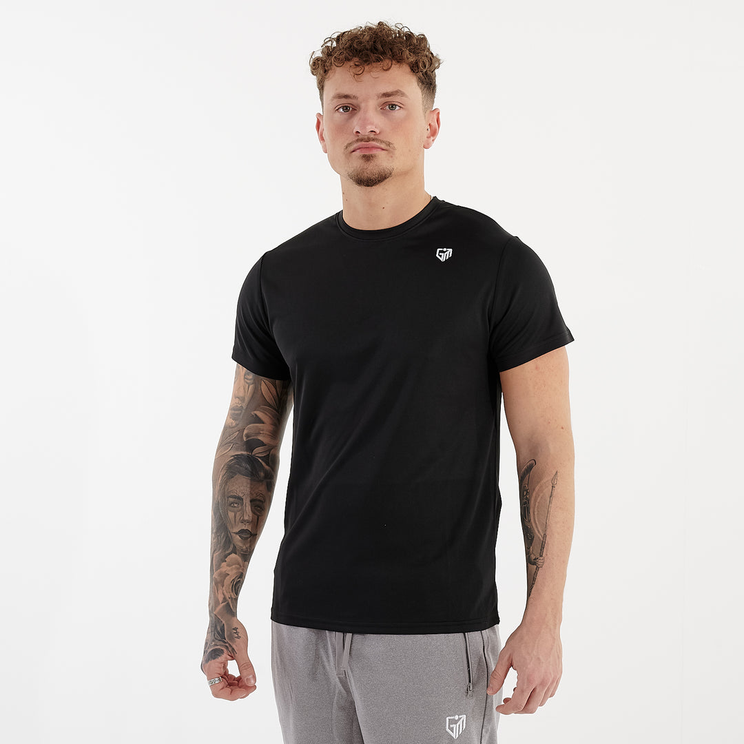 Side view of a man wearing a black performance recycled tee