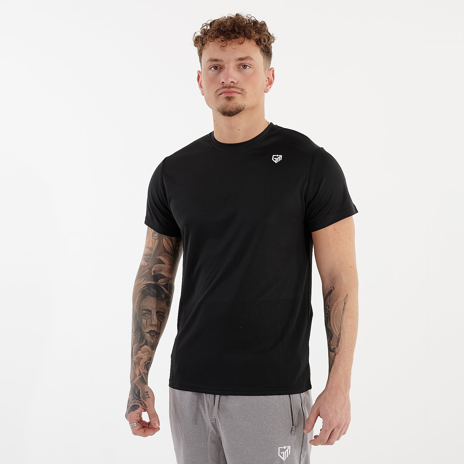 Side view of a man wearing a black performance recycled tee