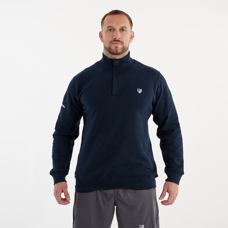 Front view of a man wearing a 1/4 zip navy sweatshirt