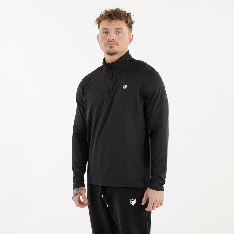 Side view of a man wearing a recycled brushed 1/4 Zip Training Top in French Navy and White