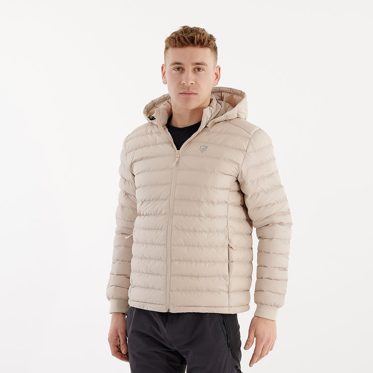 Side view of a man wearing a recycled lightweight jacket in desert dust