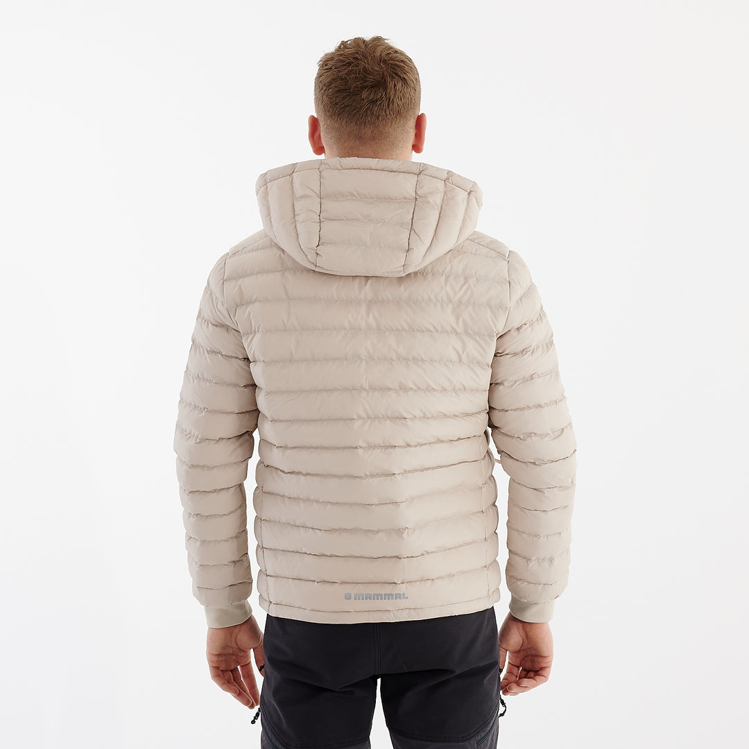 Back view of a man wearing a recycled lightweight jacket in desert dust