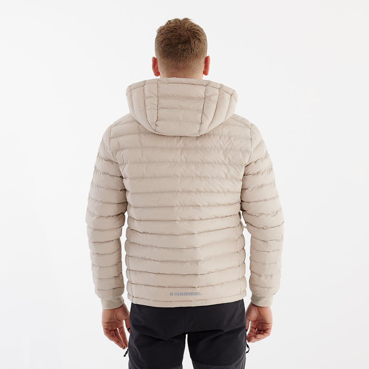 Back view of a man wearing a recycled lightweight jacket in desert dust