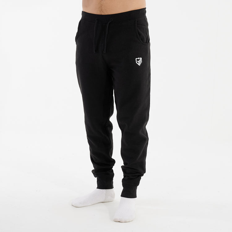 Side view of a man wearing black slim cuffed joggers