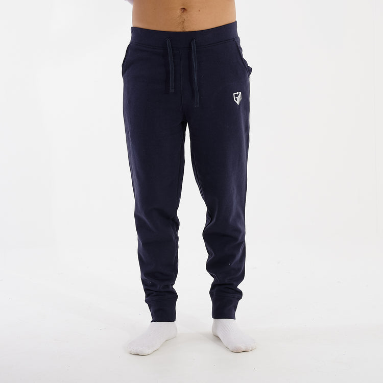 Front view of a man wearing slim cuffed joggers in navy