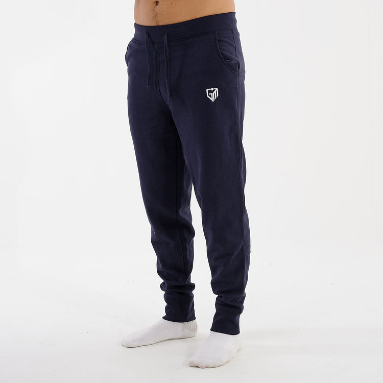 Side view of a man wearing slim cuffed joggers in navy