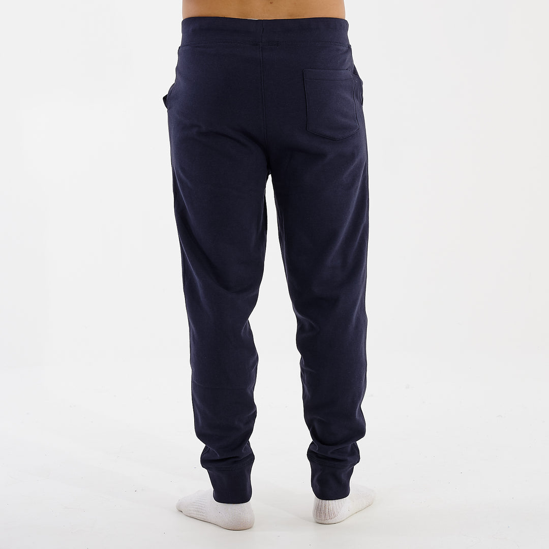 Back view of a man wearing slim cuffed joggers in navy