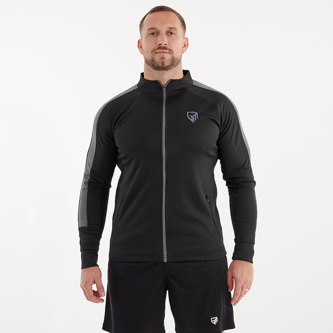 Front view of a man wearing a slim fit knitted tracksuit top in black and gunmetal