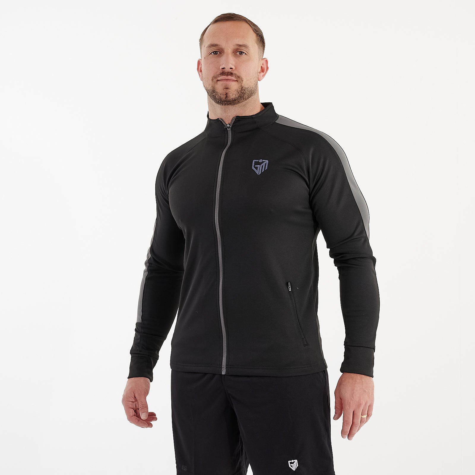 Side view of a man wearing a slim fit knitted tracksuit top in black and gunmetal