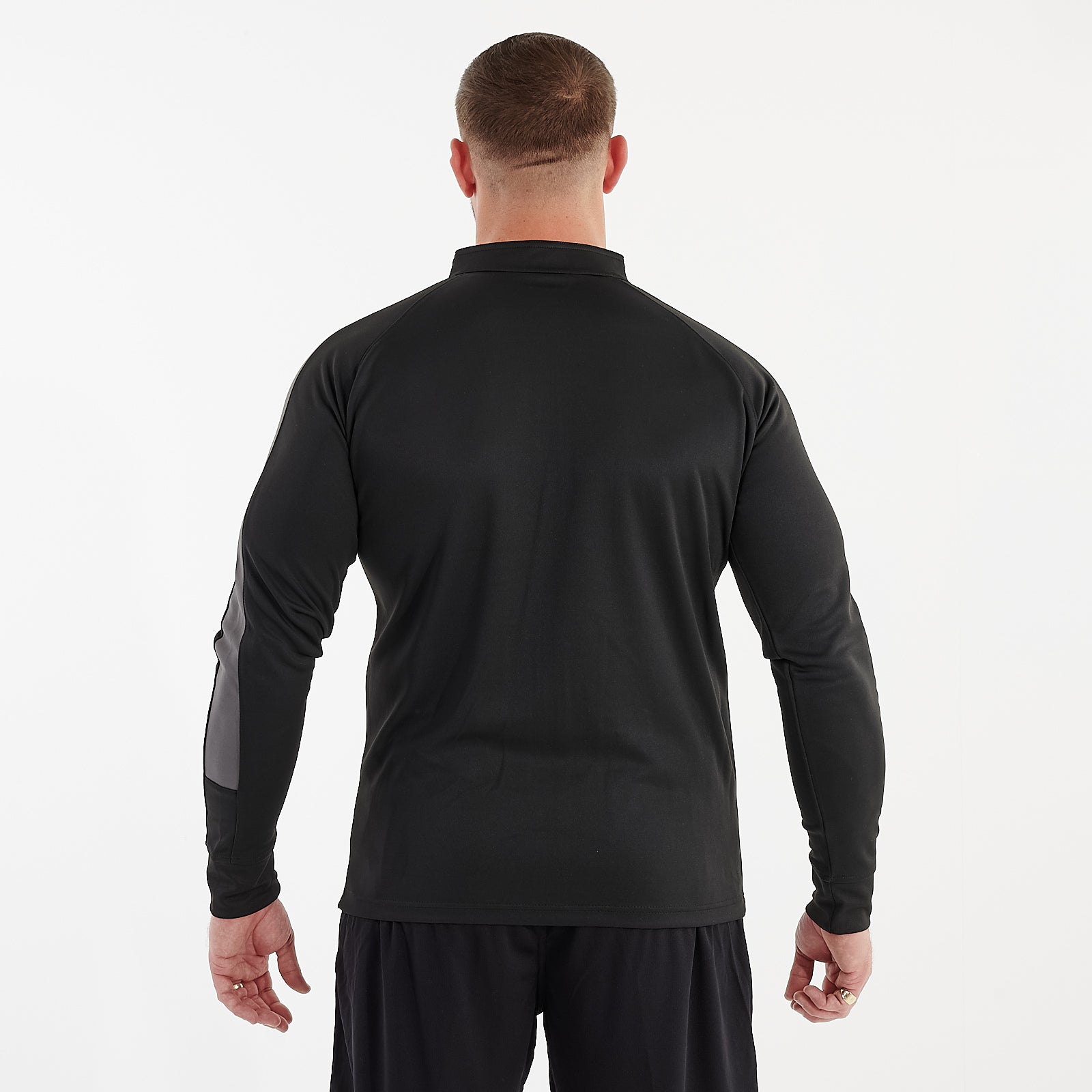 Back view of a man wearing a slim fit knitted tracksuit top in black and gunmetal