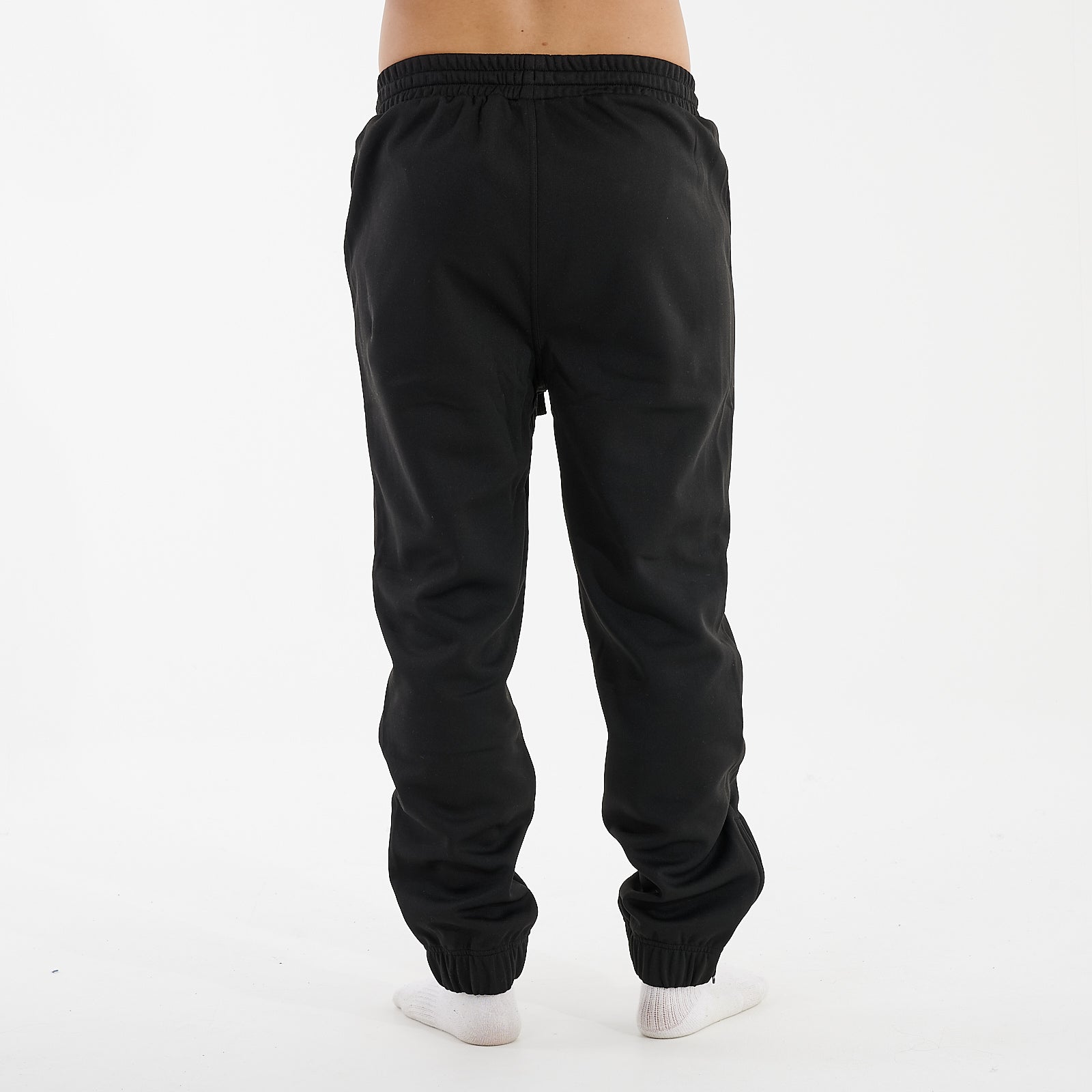 Back view of a man wearing sustainable knit joggers in black
