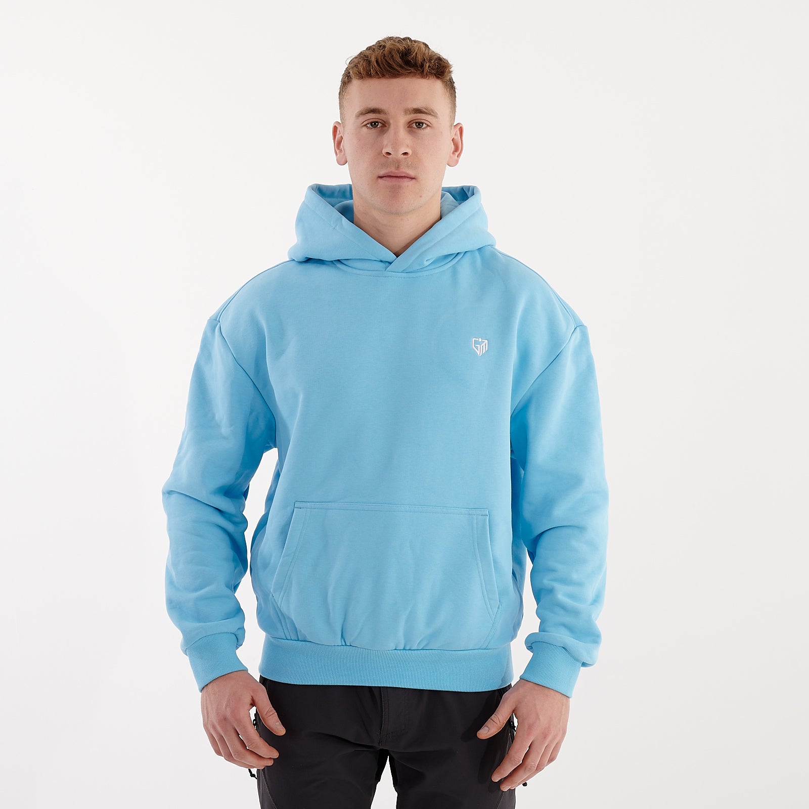 Front view of a man wearing a baltic blue oversized heavy hoodie