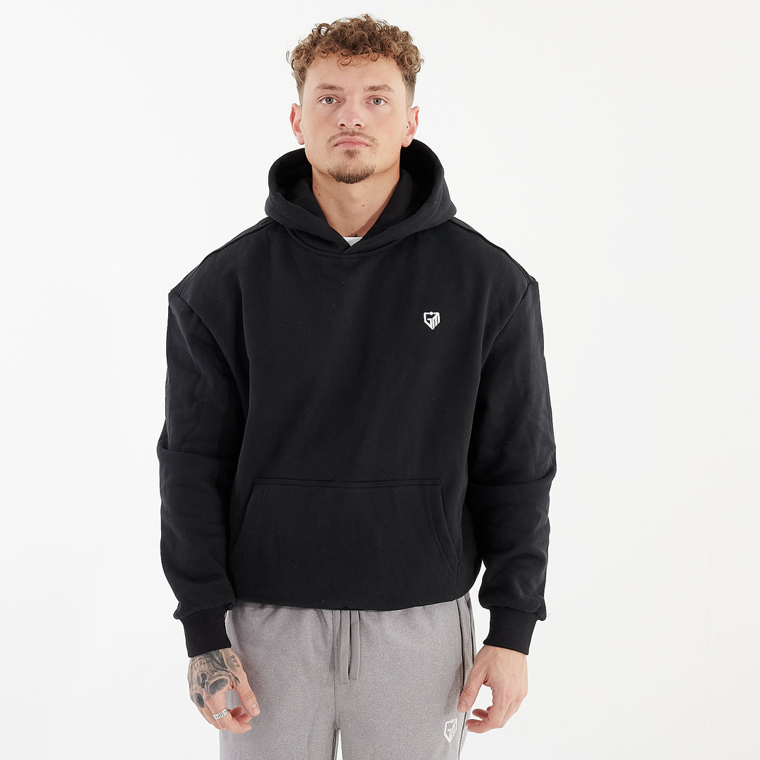 Front view of a man wearing a black oversized heavy hoodie