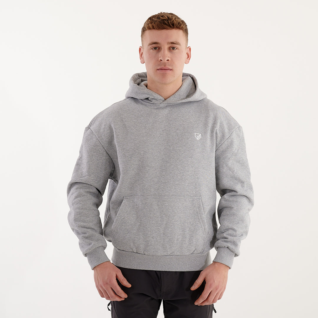 Front view of a man wearing a grey heavy hoodie