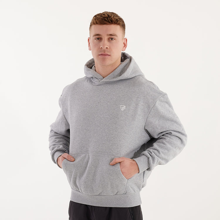 Side view of a man wearing a grey heavy hoodie