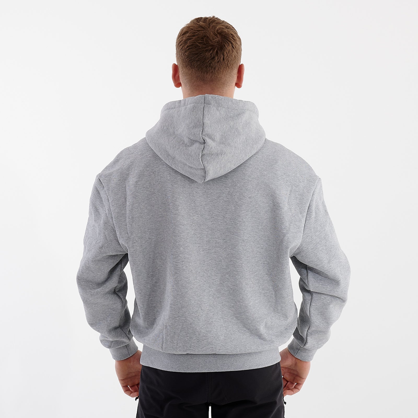 Back view of a man wearing a grey heavy hoodie