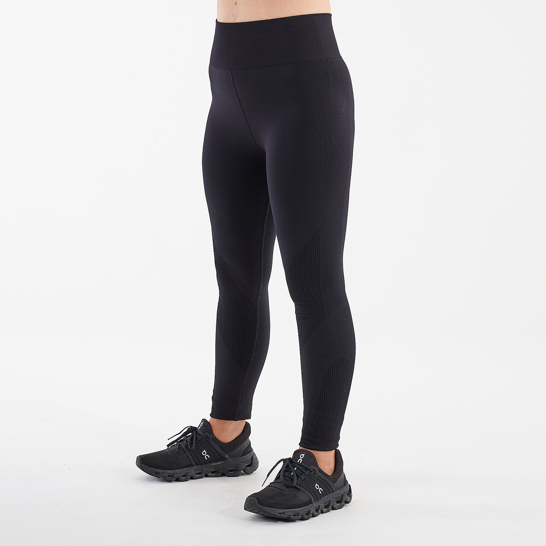 Side view of a woman wearing black sculpt fit multi sport leggings