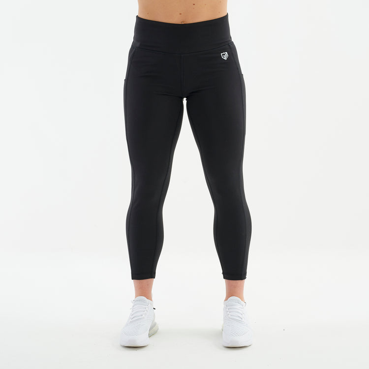 Front view of a woman wearing black 7/8 recycled performance leggings