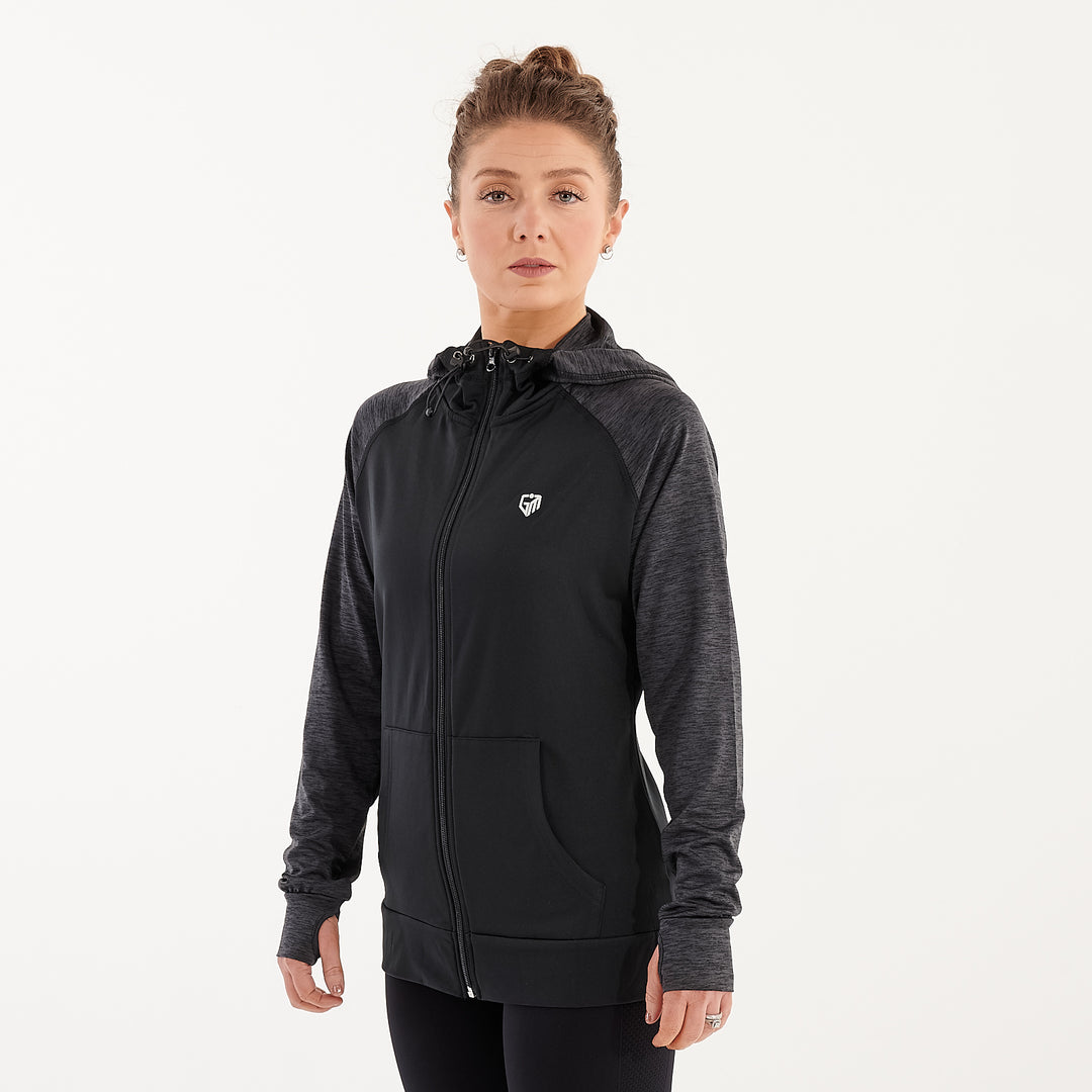 Side view of a woman wearing a black performance contrast hoodie