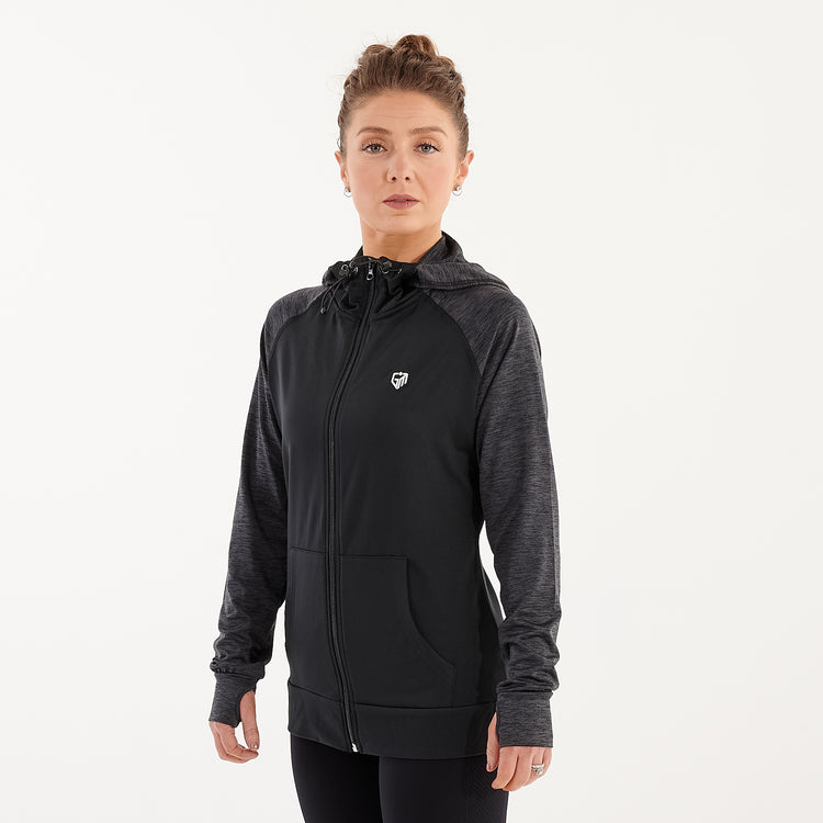 Side view of a woman wearing a black performance contrast hoodie