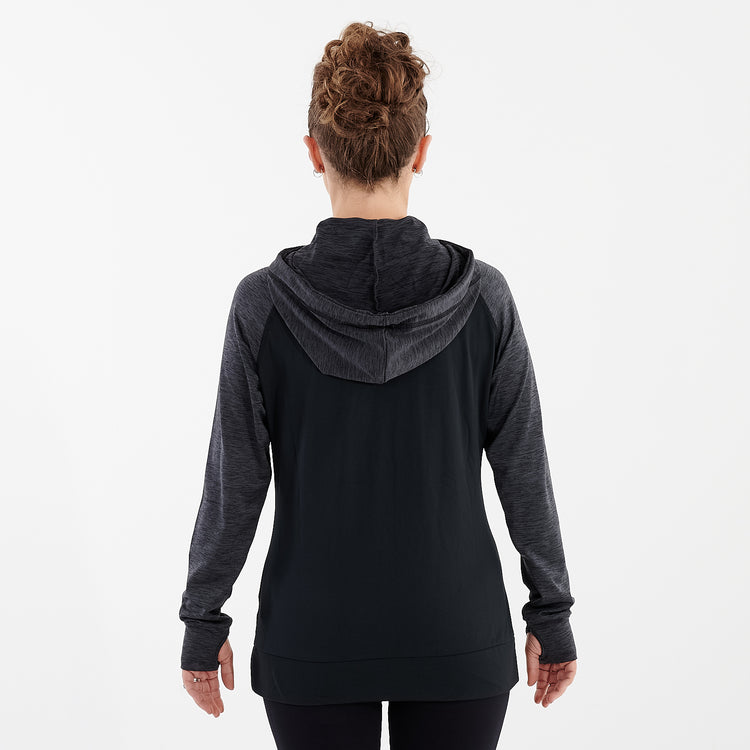 Back view of a woman wearing a black performance contrast hoodie