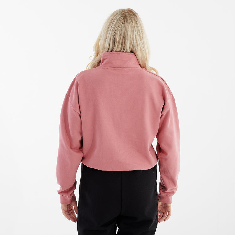 Back view of a women wearing a pink cropped 1/4 zip sweatshirt