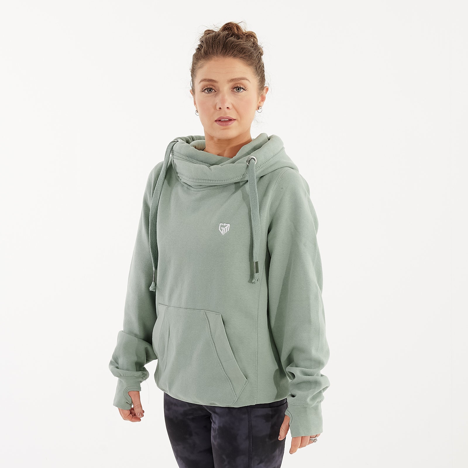 Side view of a woman wearing a dusty green heavyweight hoodie