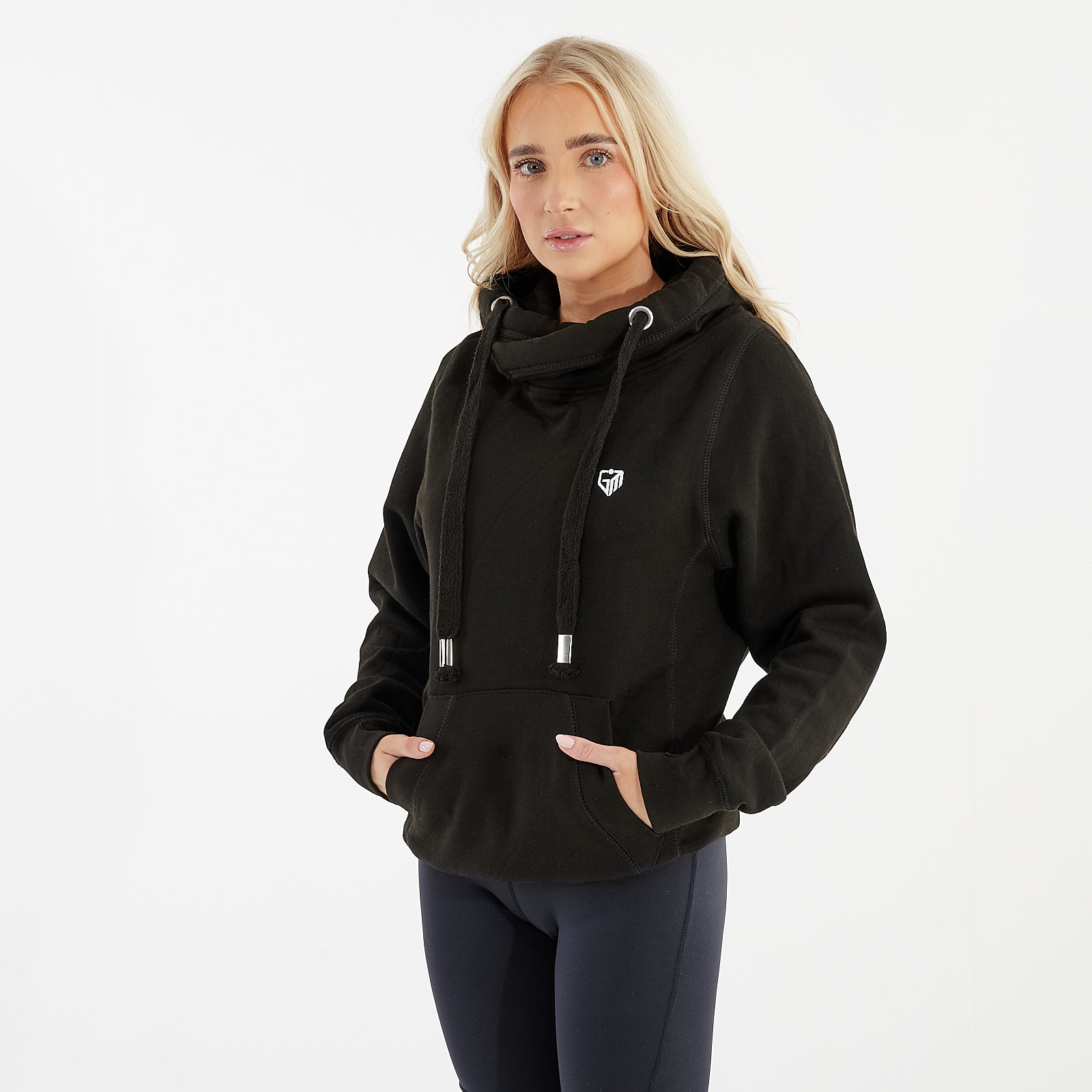 Side view of a woman wearing a black heavyweight cross neck hoodie