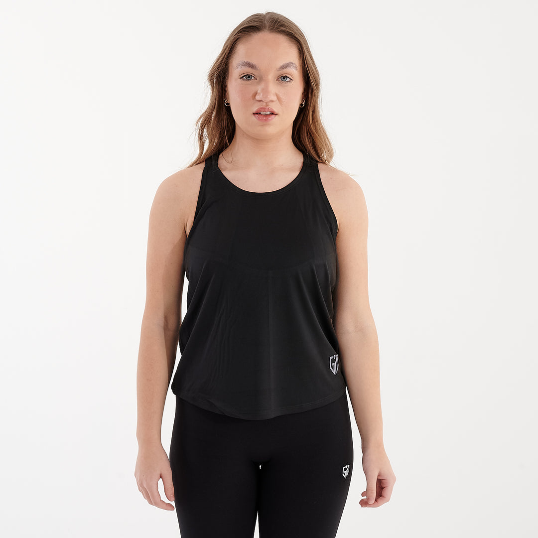 Front view of a woman wearing a strappy black performance vest.