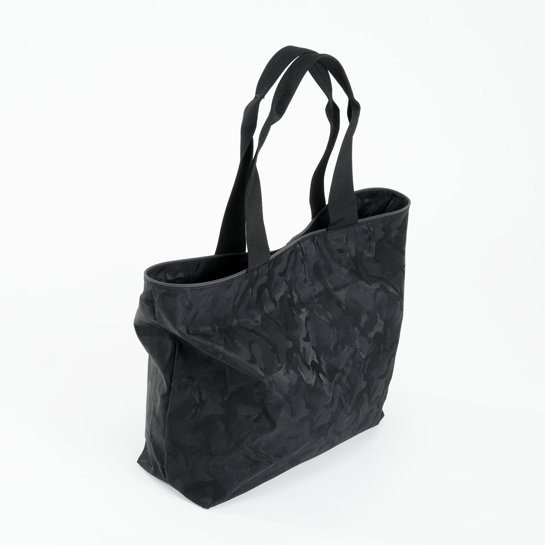 Side view of a black camo everyday tote bag