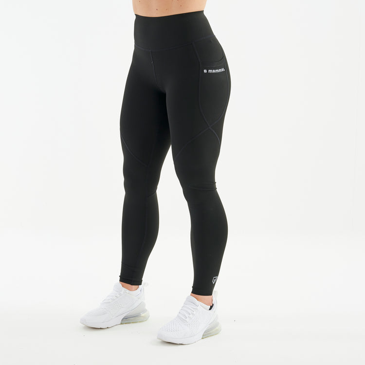 Side view of a woman wearing black hourglass sculpt leggings