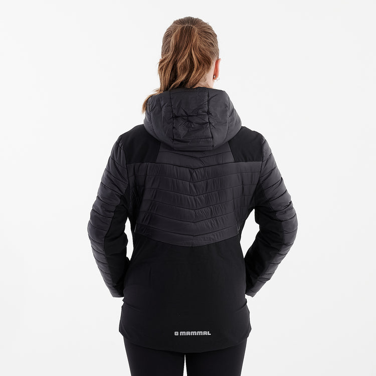 Back view of a woman wearing a black insulated hybrid jacket
