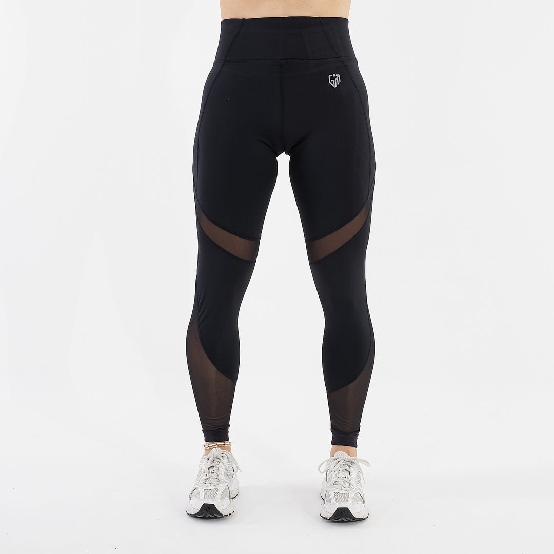 Front view of a woman wearing full length mesh panel leggings