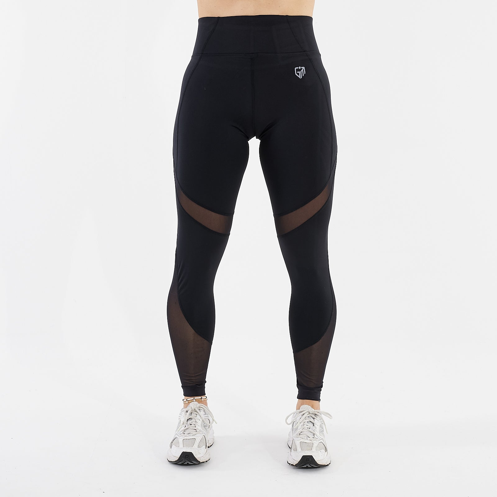 Front view of a woman wearing full length mesh panel leggings